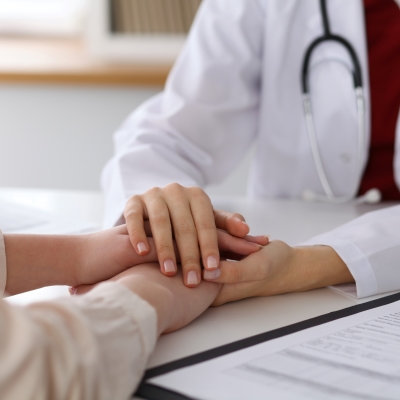 doctor holding patient hand