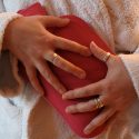 Woman clutching heating pad