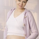 pregnant woman standing and holding on to her stomach