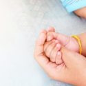 mom holding baby's hand