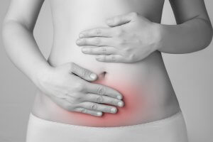 Young woman having abdominal pain