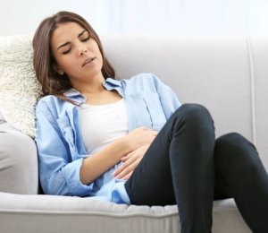 woman in pain from heavy bleeding photo