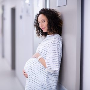 pregnant ethnic woman in hospital hall 400x400