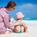 woman with baby on beach sunscreen