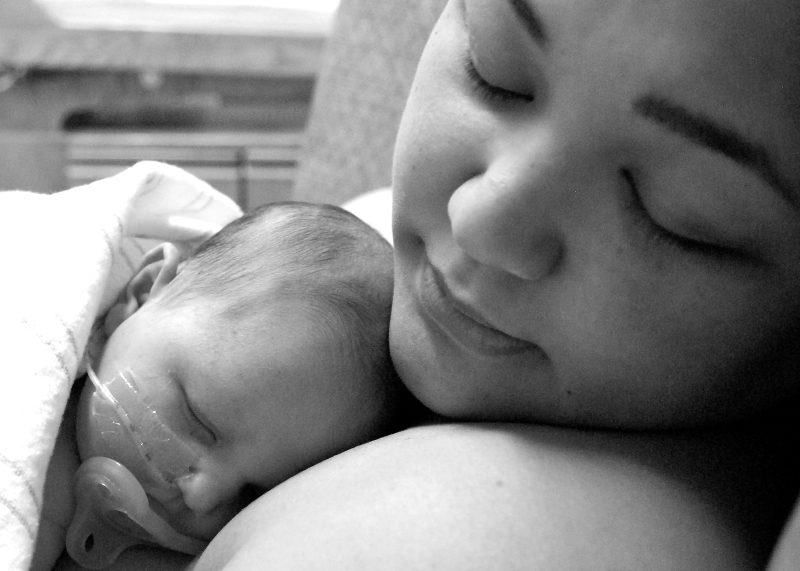 New born baby - girl with remainder of umbilical cord after successful  childbirth. Real birthing and new