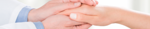 ob/gyn holding hands with patient
