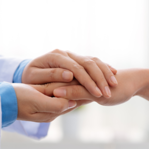 doctor holding patient's hand